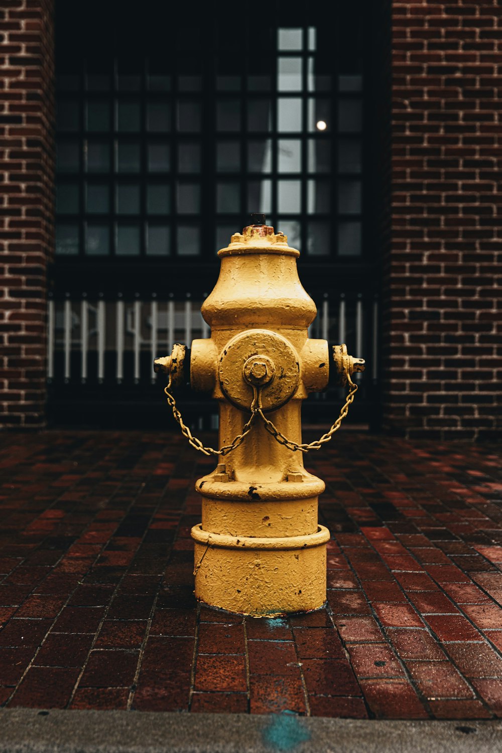 brown concrete outdoor fountain in front of brown brick wall