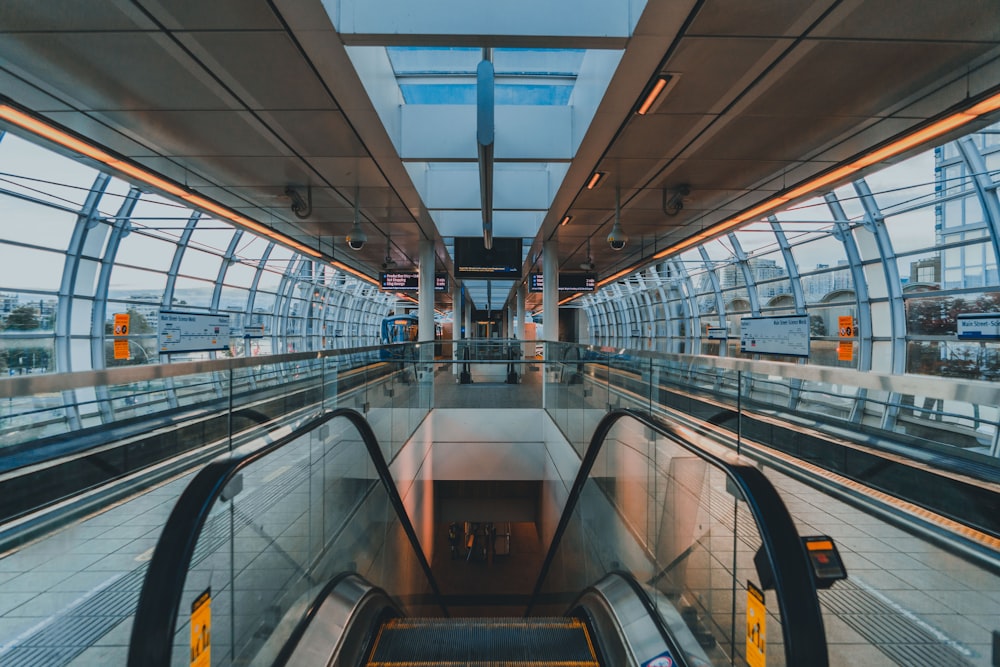 an escalator in a subway station with a view of the escalators