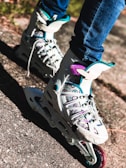 Close-up of a skater's colorful roller skates gliding smoothly over a polished rink floor.