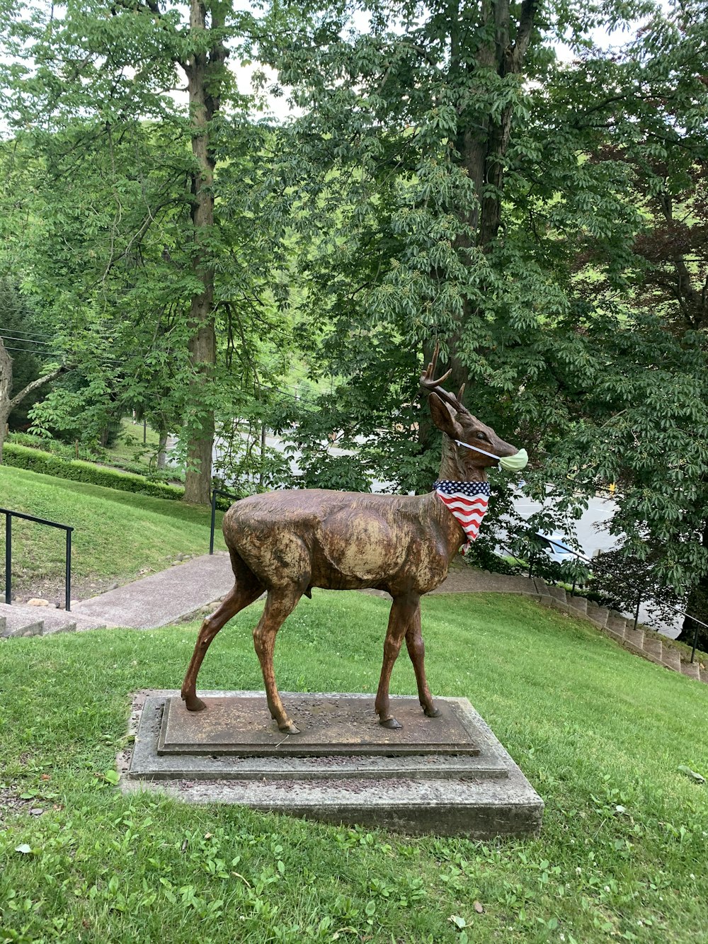 brown deer statue on gray concrete pathway