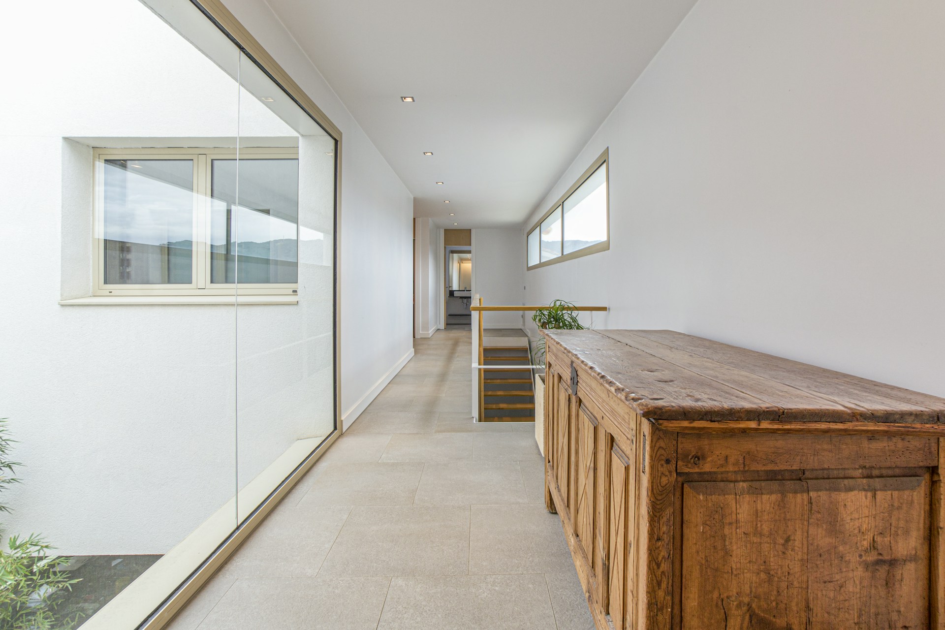 brown wooden table near white wall