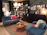 A cozy living room featuring dark and light blue wooden furniture from águanobre.