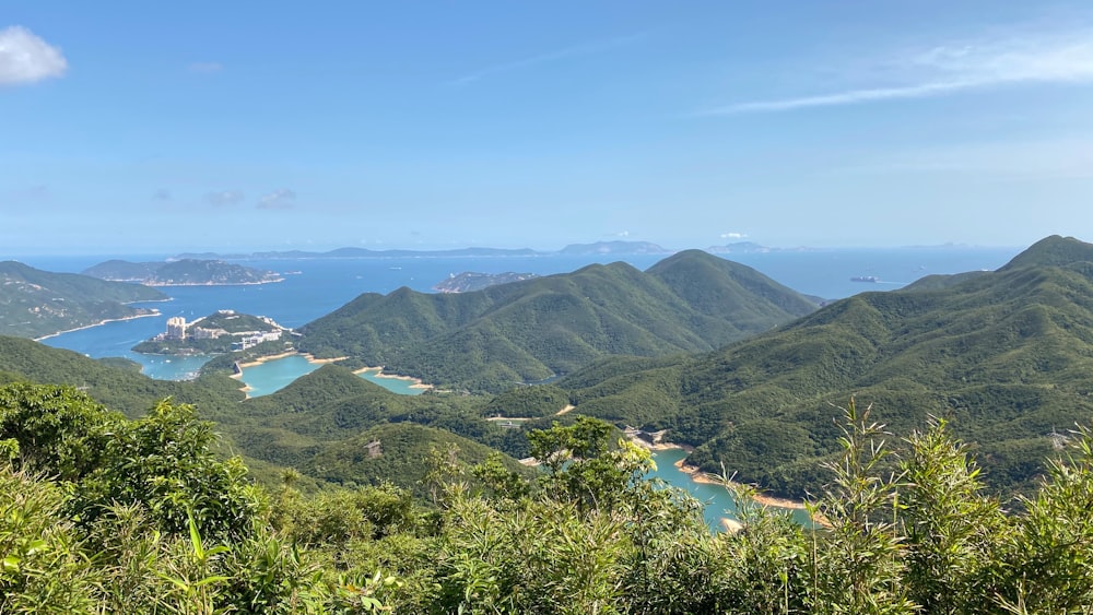 green mountains near body of water during daytime