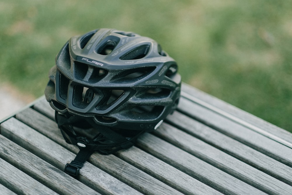 black plastic ball on gray wooden plank