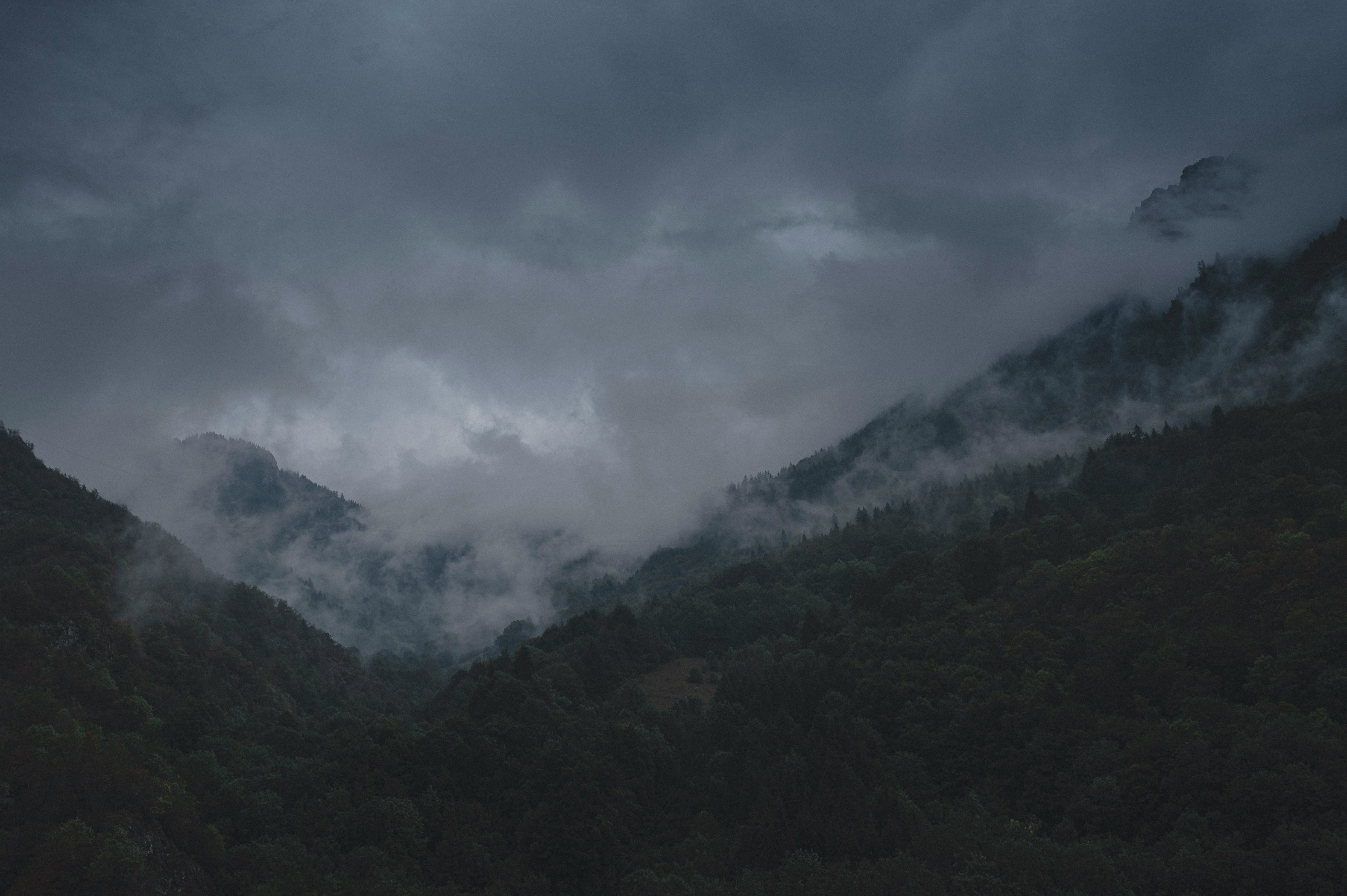 green mountains under white clouds during daytime