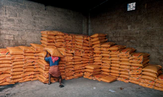 person in blue shirt and black pants sitting on brown wooden chair
