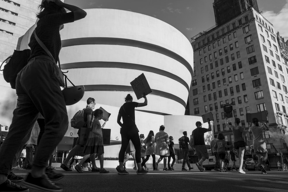 grayscale photo of people walking on street