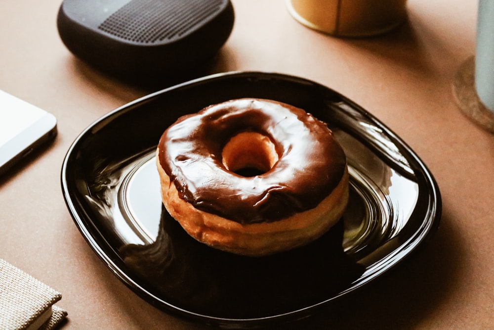 brown doughnut on black ceramic plate