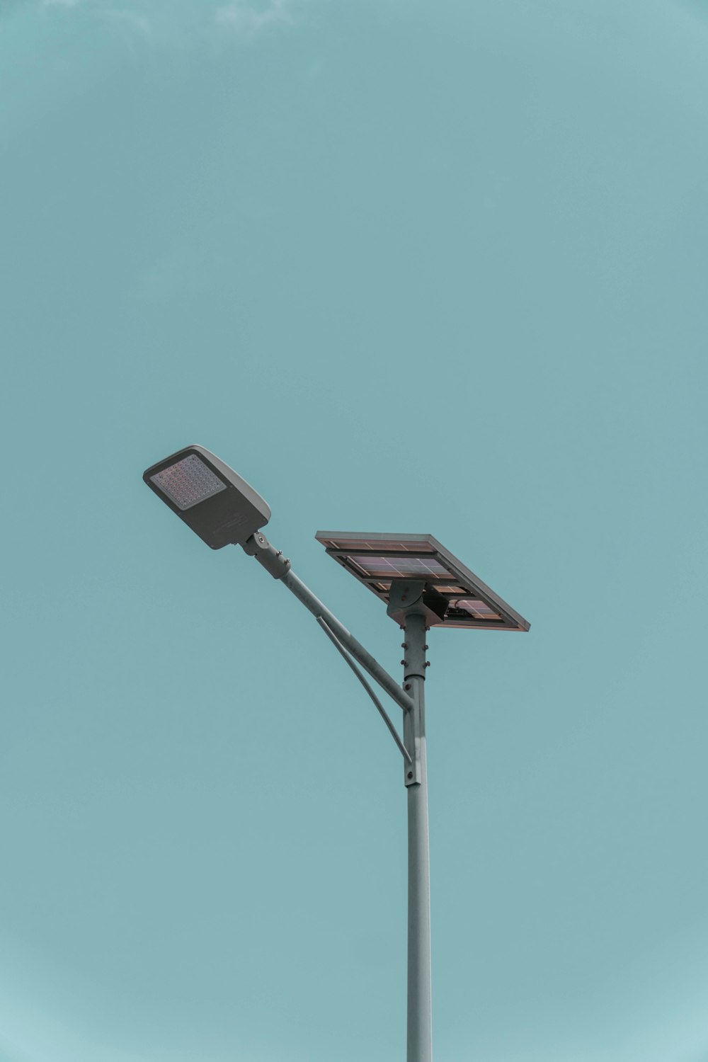 black and white street light under blue sky during daytime