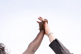 Two people clasping hands and celebrating victory
