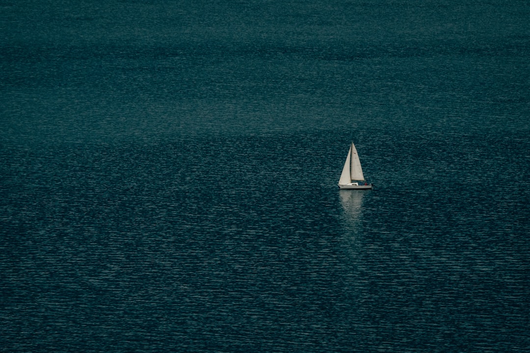 white sailboat on blue sea during daytime