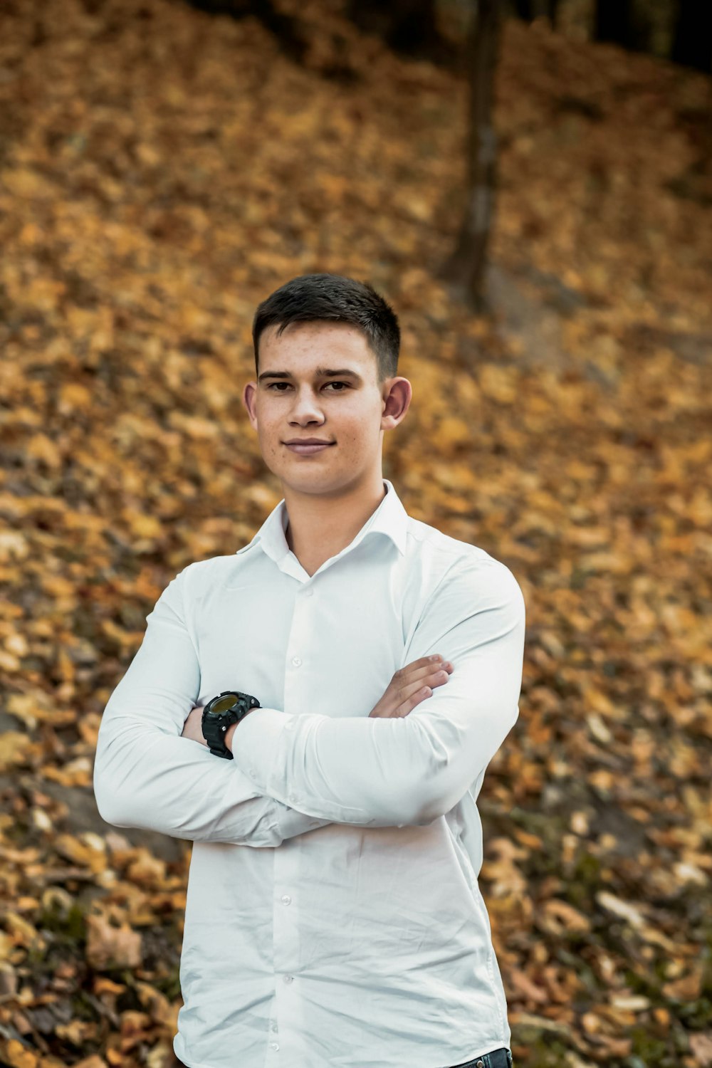 man in white dress shirt standing and smiling