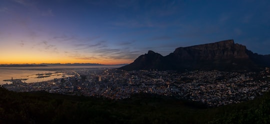 city with high rise buildings near mountain under blue sky during daytime in Signal Hill South Africa