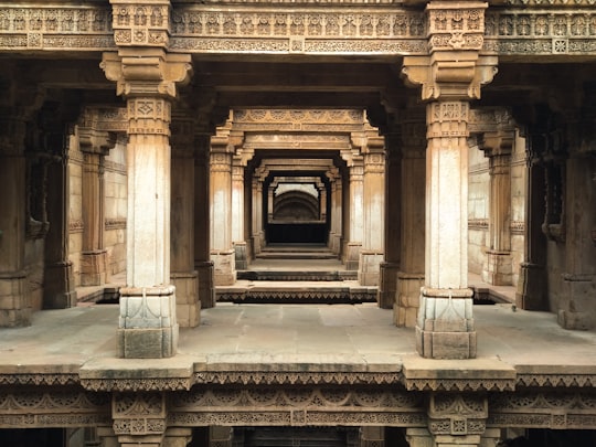 brown concrete building during daytime in Adalaj Stepwell India