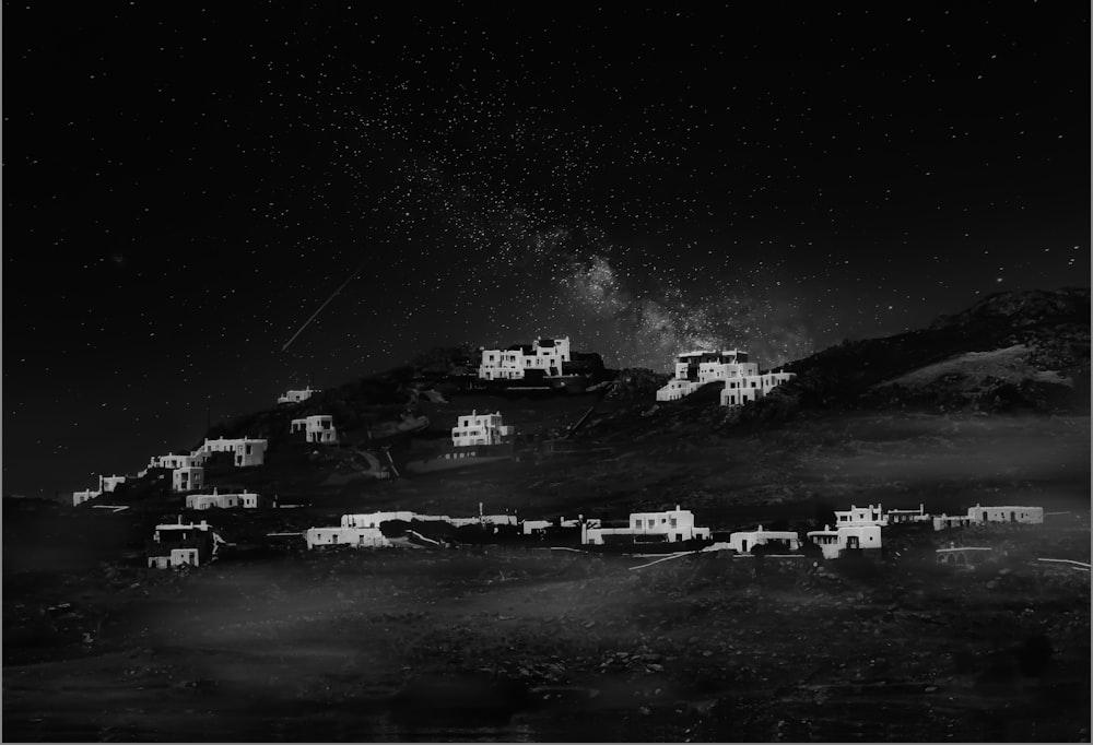 grayscale photo of houses on hill