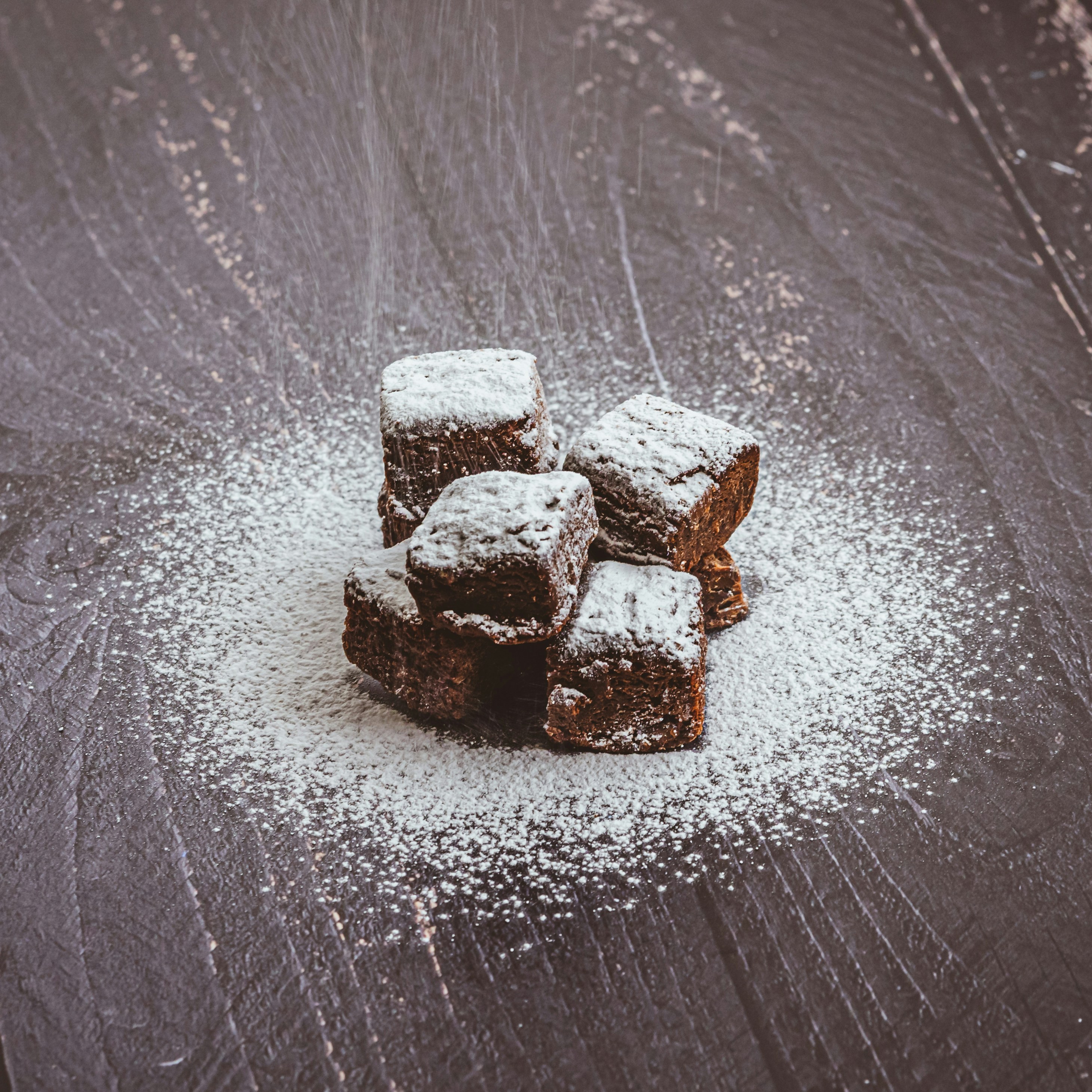 brown and white heart shaped chocolate bars on gray surface