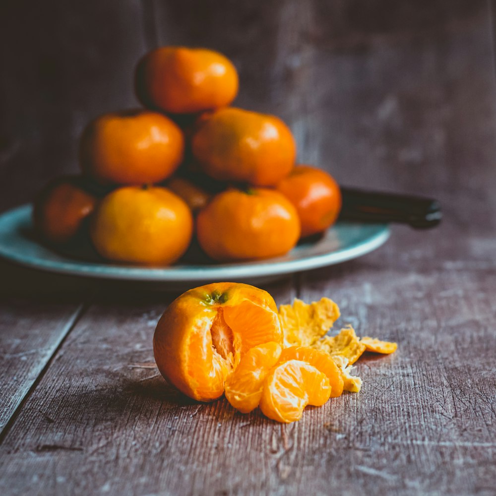 orange fruits on blue ceramic plate