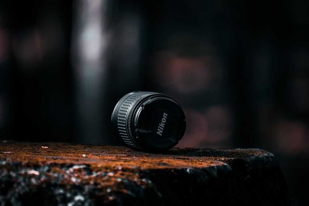 black camera lens on brown wooden table