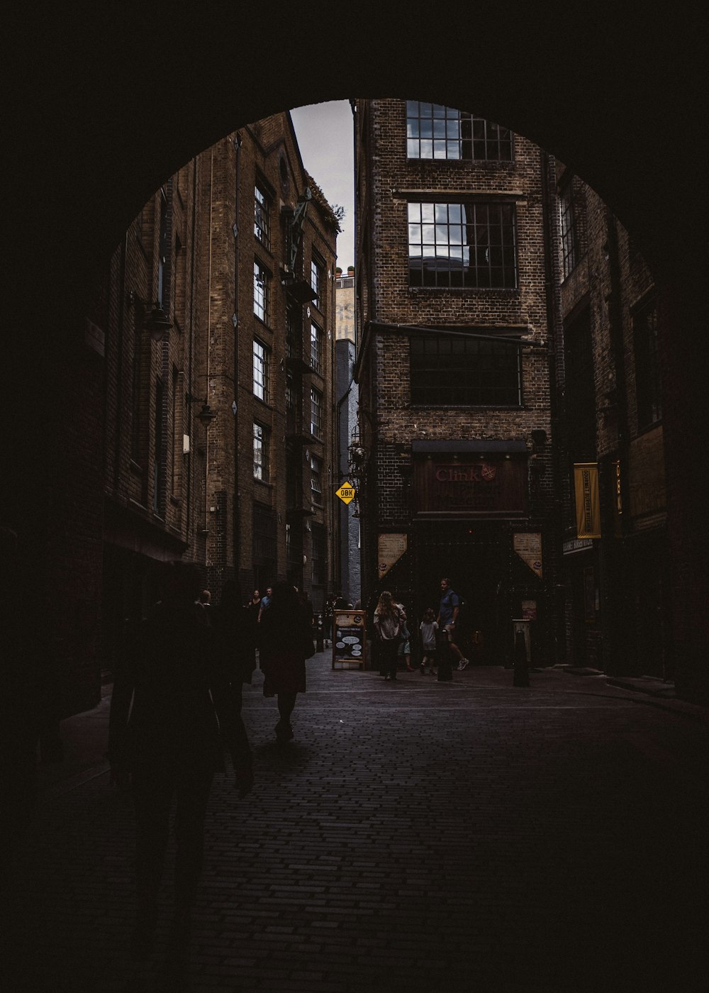 people walking on street between high rise buildings during daytime