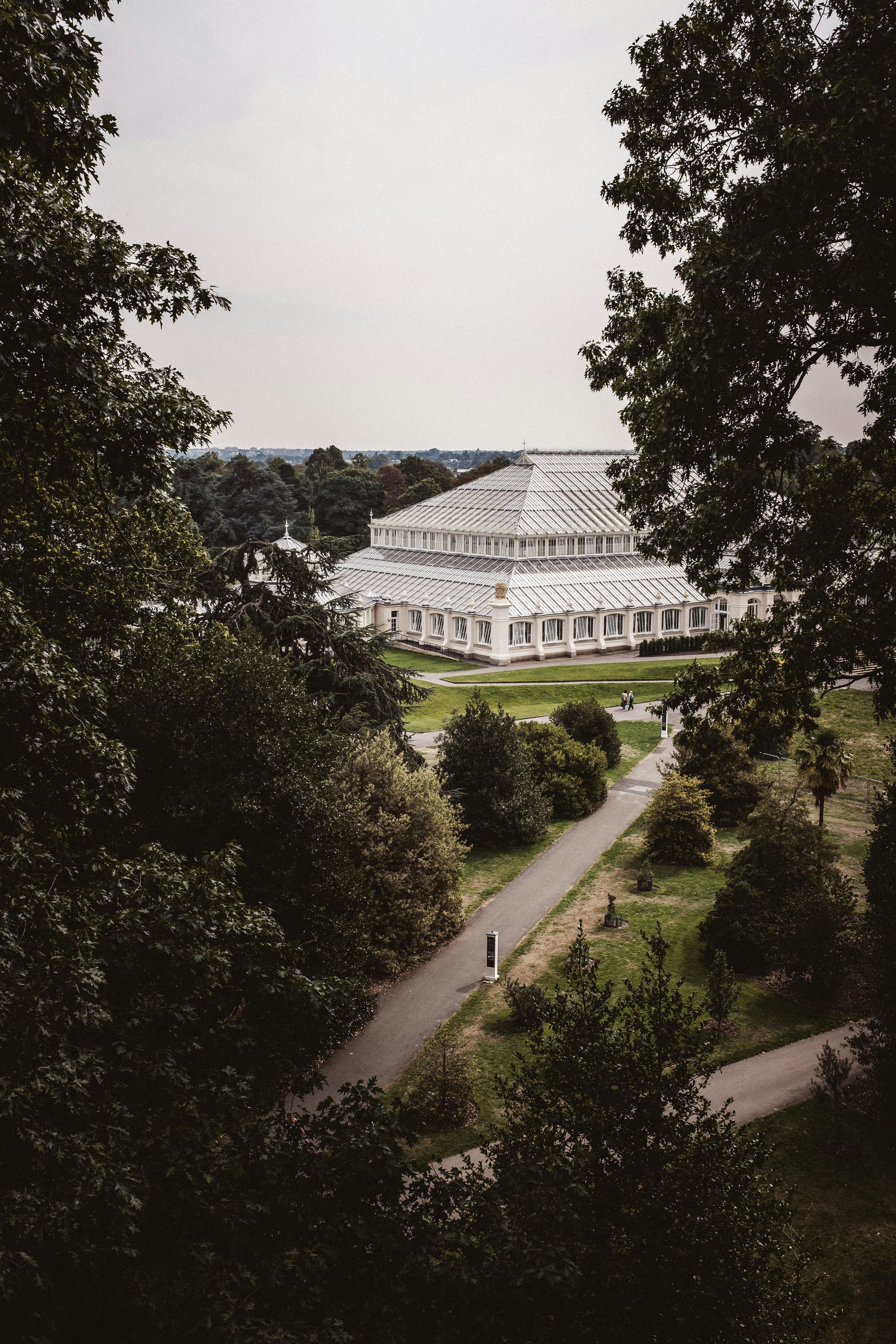 white concrete building surrounded by green trees during daytime