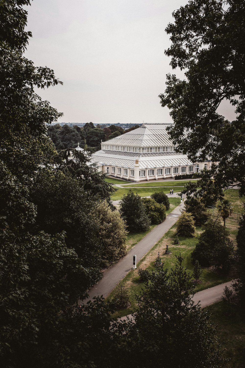 white concrete building surrounded by green trees during daytime