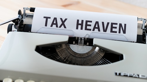 a close up of a typewriter with a tax heaven sign on it