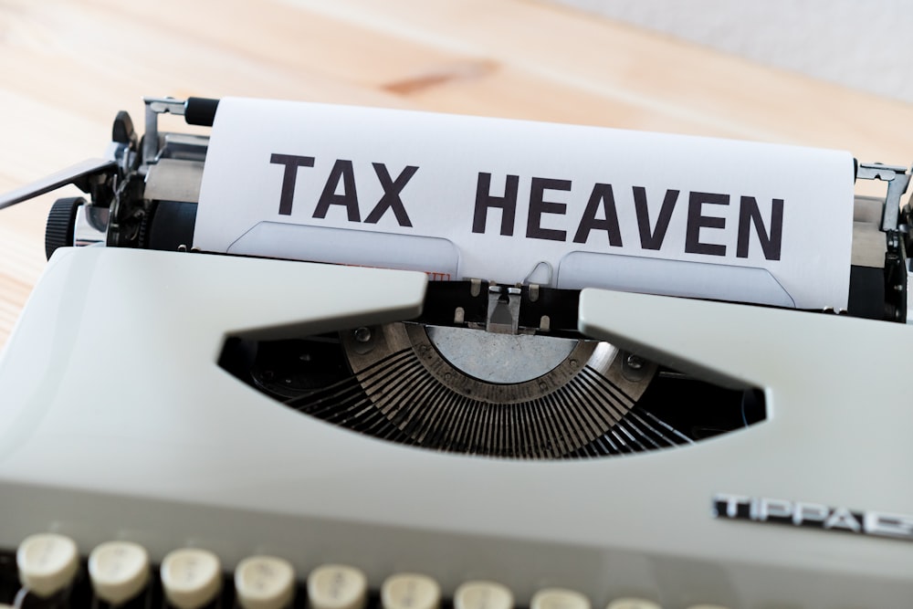 a close up of a typewriter with a tax heaven sign on it