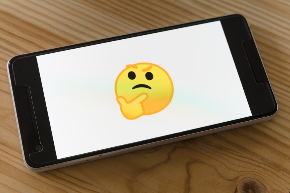 Phone with confused emoji