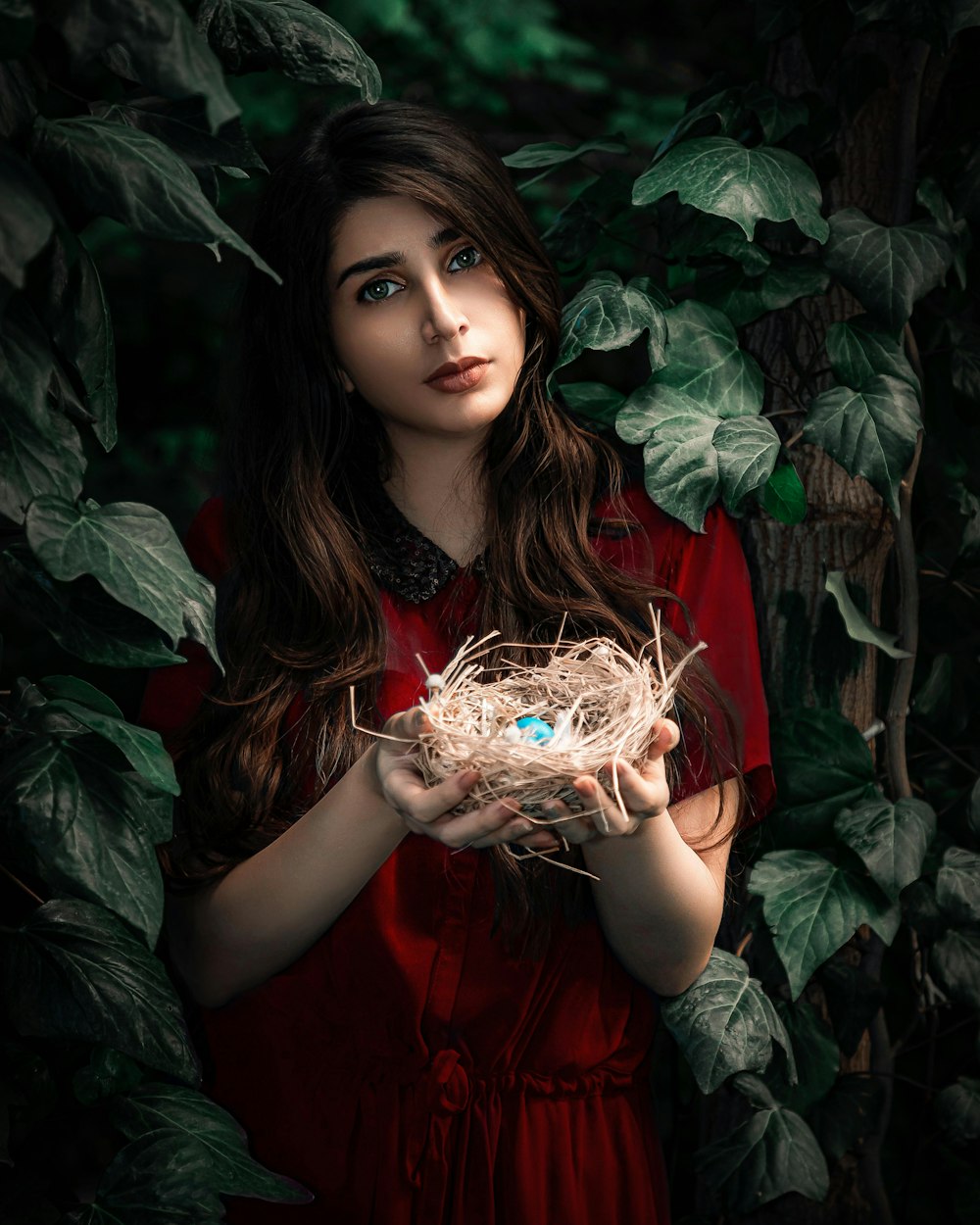 girl in red dress holding white flower