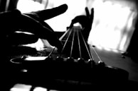 Close-up of Paymon’s hands skillfully playing an acoustic guitar during an intimate performance.