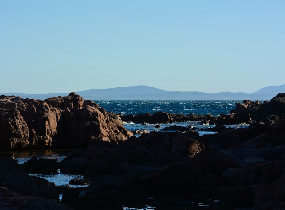 brown rock formation on sea shore during daytime