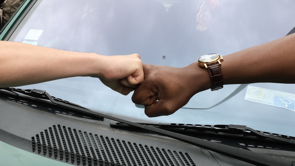 person wearing gold round analog watch