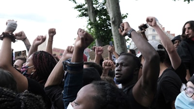 people raising their hands during daytime