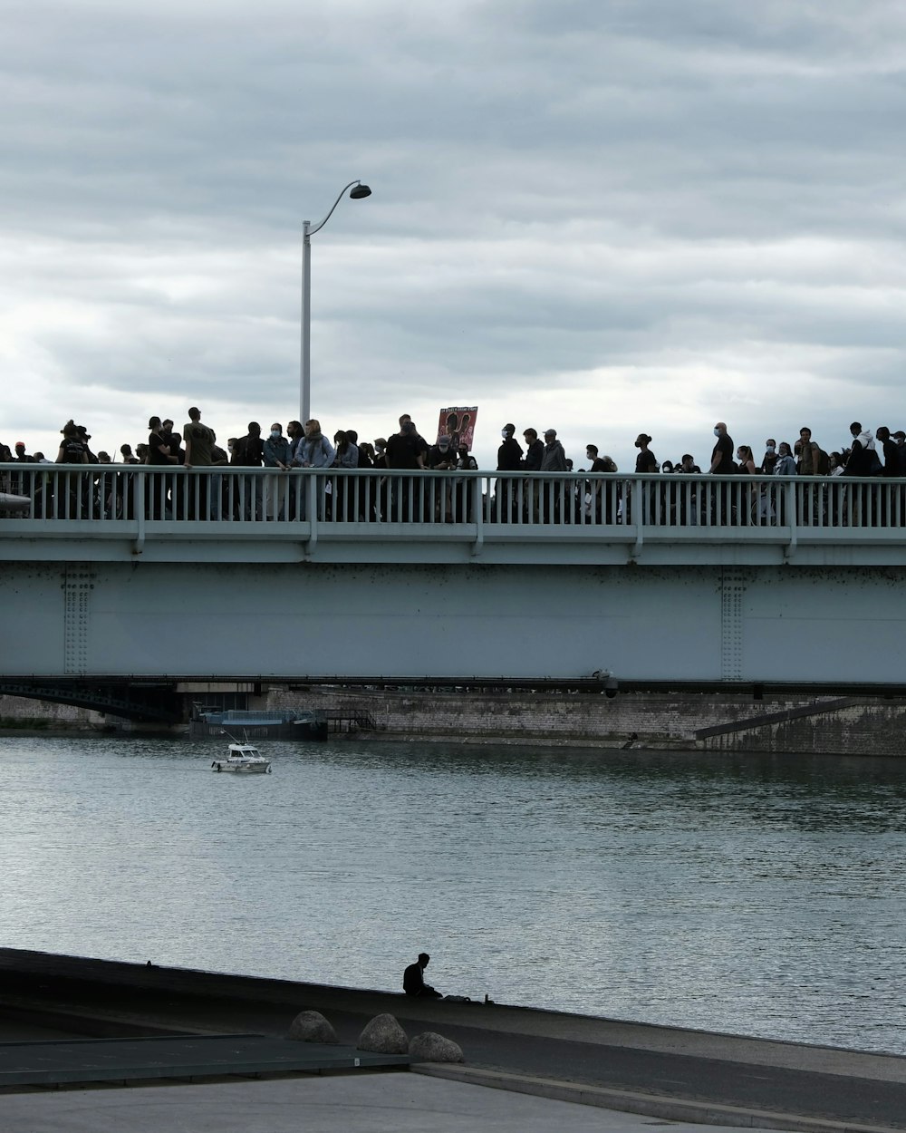 people walking on bridge over river during daytime