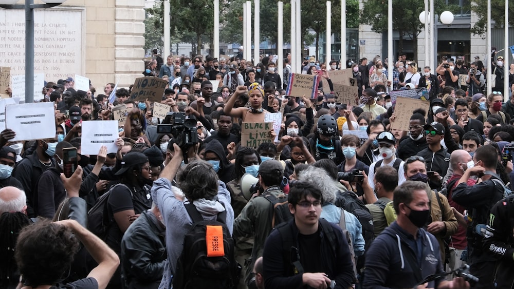 people standing near white building during daytime