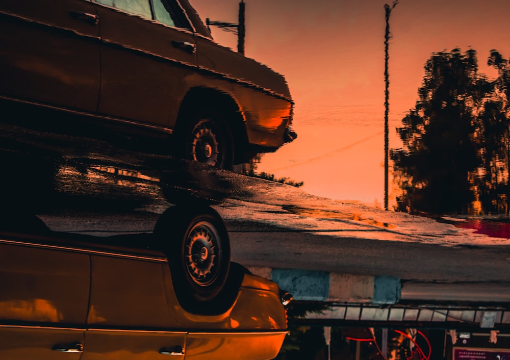 brown car on snow covered ground during sunset