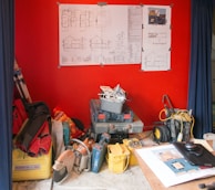 A clean, organized workspace with remodeling tools and blueprints.
