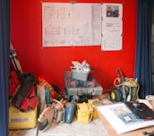 Blueprints and construction tools laid out on a work table.