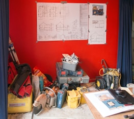 Blueprints and construction tools laid out on a work table.
