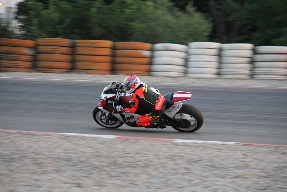 man riding on red sports bike