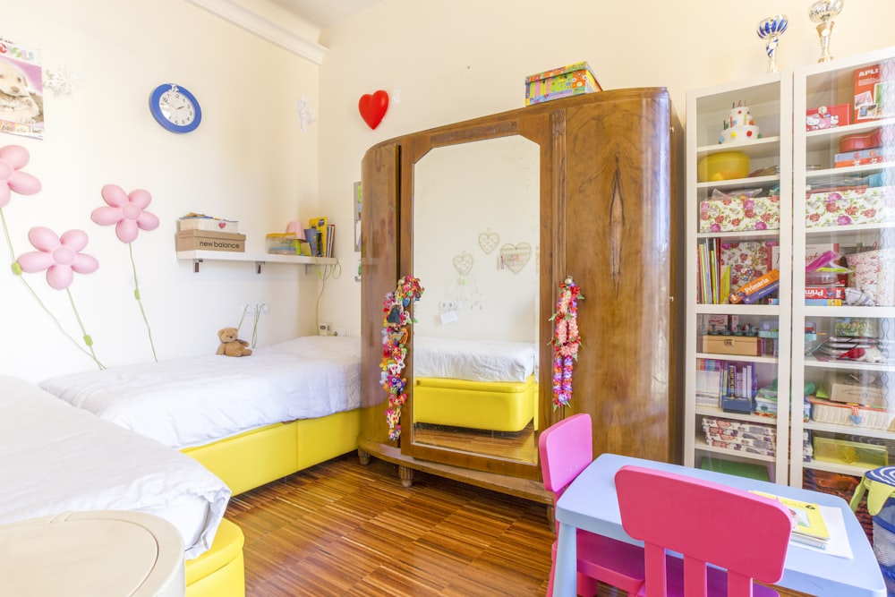 brown wooden cabinet beside white bed