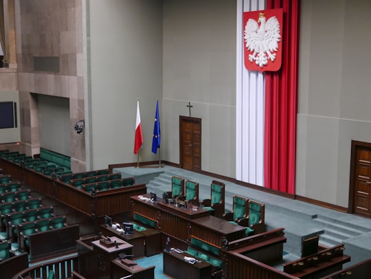 red white and blue flag on white wall in Warsaw Poland