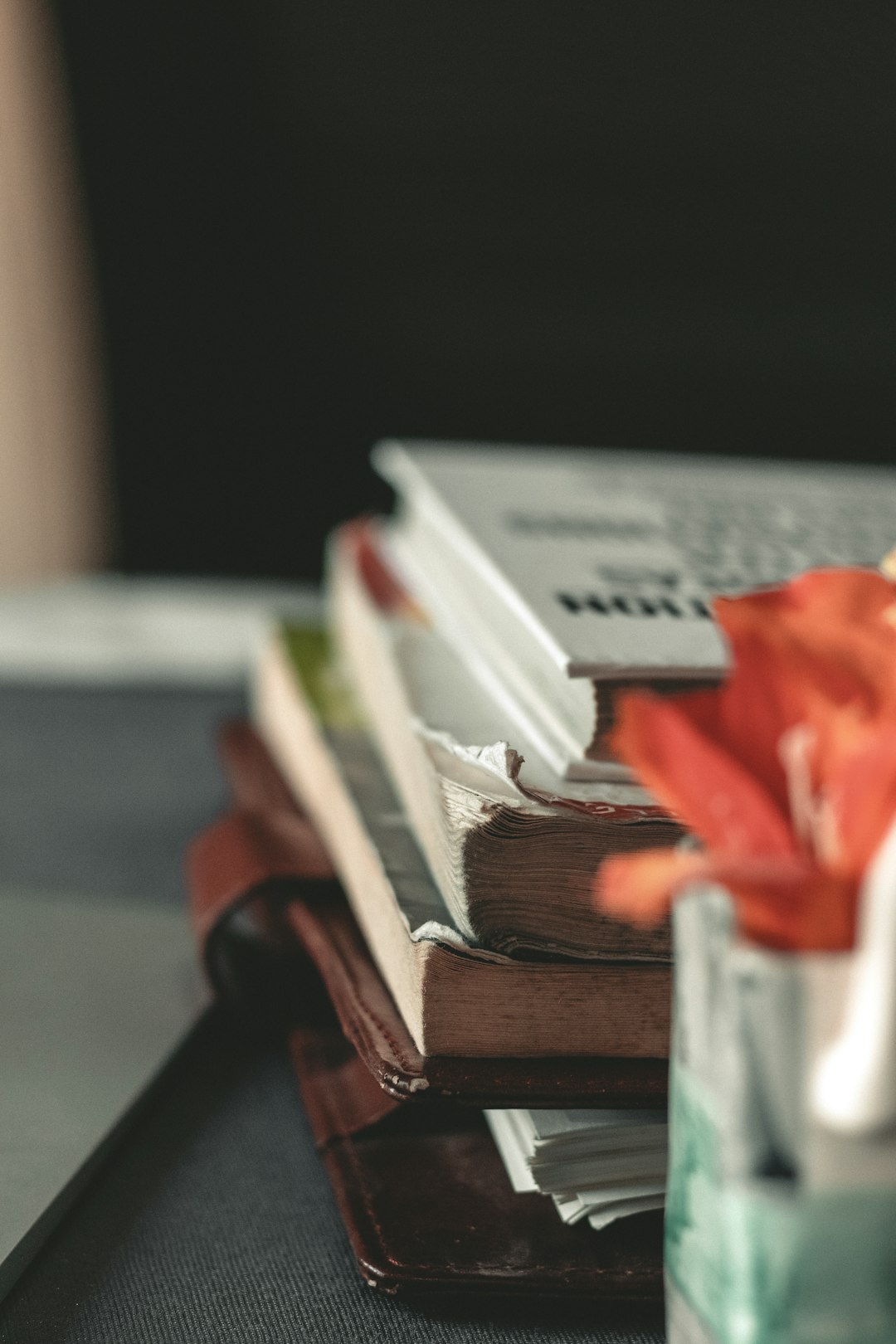 stack of books on brown wooden table