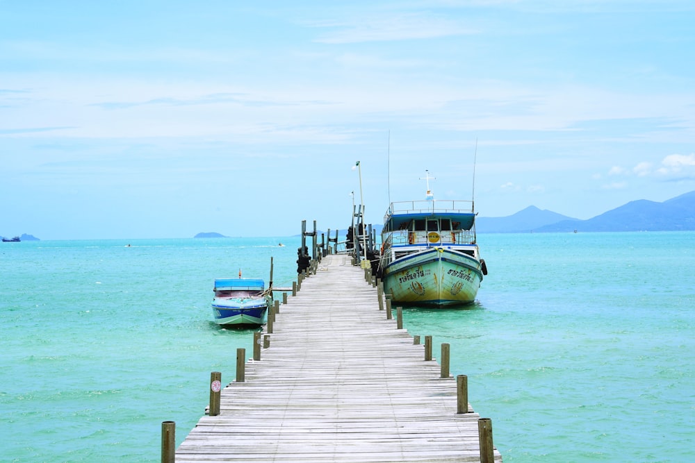 blue and white boat on sea during daytime