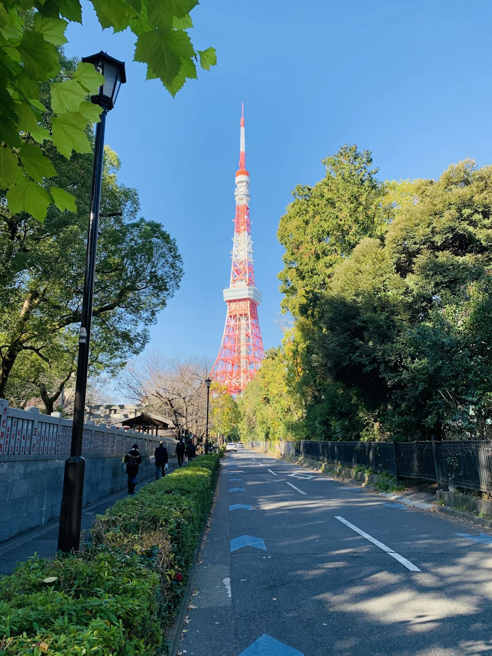 brown and white tower near green trees during daytime