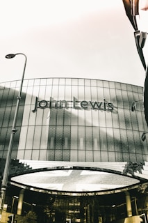 grayscale photo of building with glass windows