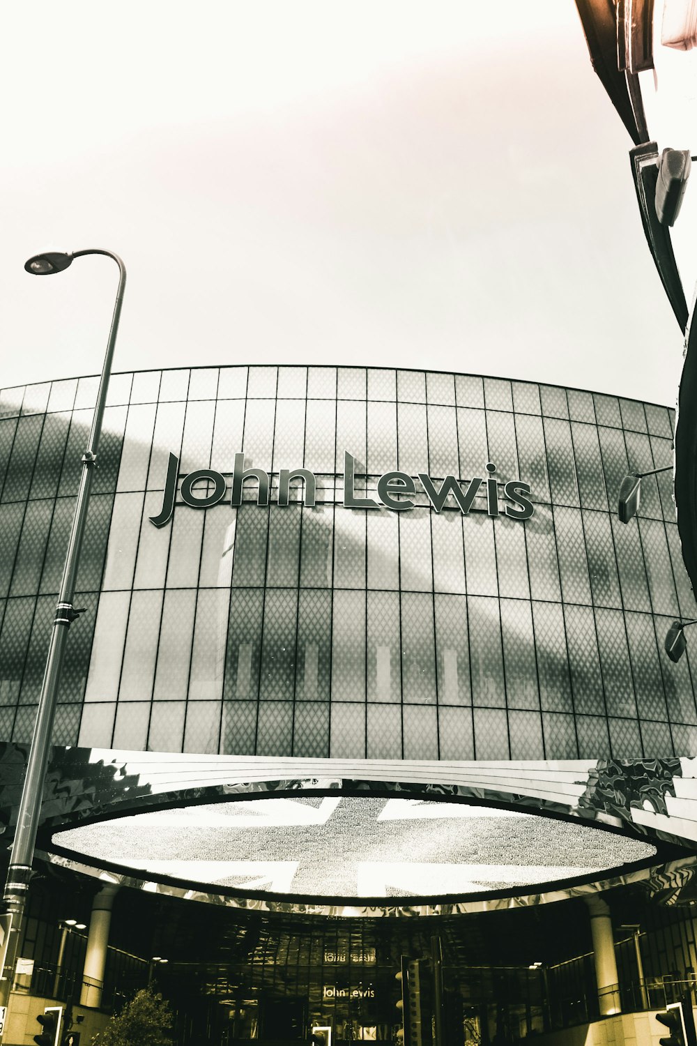 grayscale photo of building with glass windows