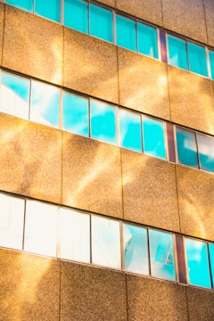 A panoramic view of a completed commercial building with glass facades and golden accents.