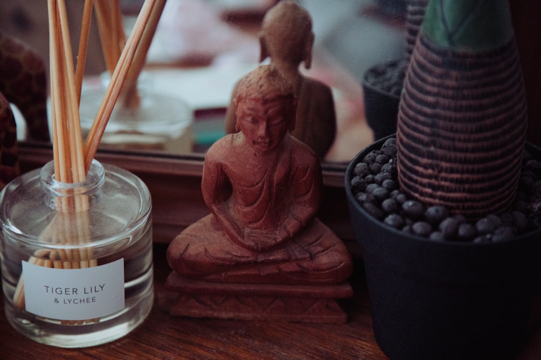 brown ceramic angel figurine on brown wooden table