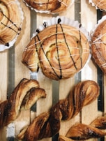 Freshly baked pastries displayed on a wooden counter.